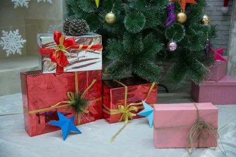 Present boxes at christmas tree. happy new year. celebrate xmas at home. wint Stock Photos