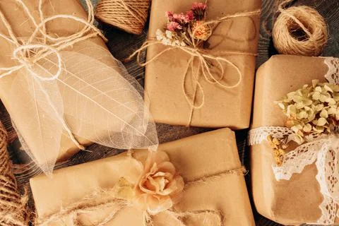 Present boxes in florist rustic romantic style in ecological floristic wrapping. Stock Photos