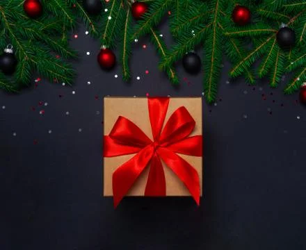 Present with decorations on black background Stock Photos