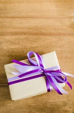 Present with Empty Tag on Wooden Background. Stock Photos