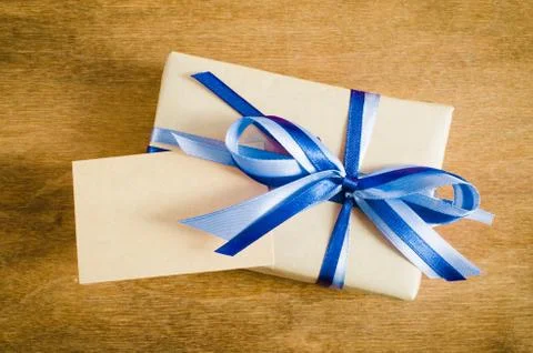 Present with Empty Tag on Wooden Background. Stock Photos