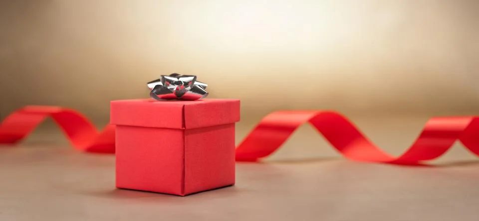 Present  in front of beige background Stock Photos