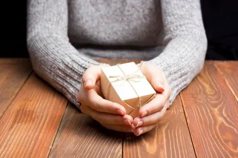Present,  gift. Close up of female hands holding small gift Stock Photos