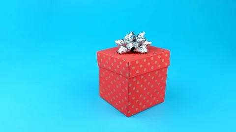 Present or gift box with bow on top, moves on the ground, tries to open Stock Footage 97167259