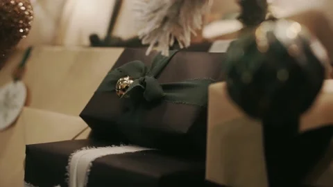 Present or gift wrapped with black wrapping paper and green ribbon with a Stock Footage 226146484
