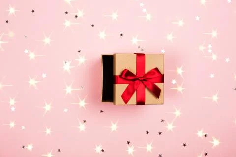 Present with red bow on pink background Stock Photos