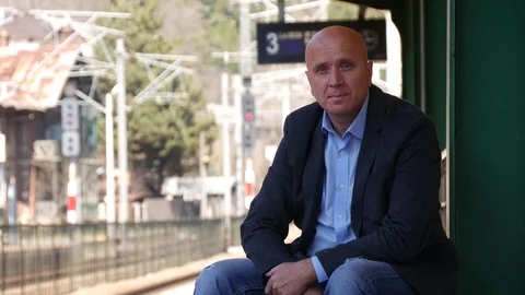 Presentable and Handsome Person Waiting on Railway Platform Looking to Camera Video stock 74987605