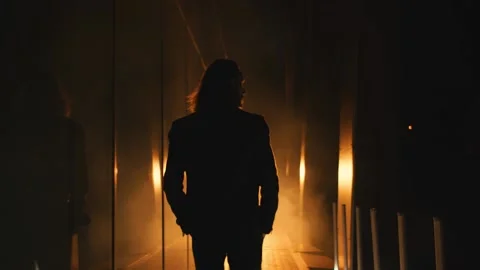 Presentable man walks into the spotlights Stock Footage 141935519