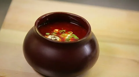Presentation and serving russian borscht with sour cream in a pot 動画素材 58408432