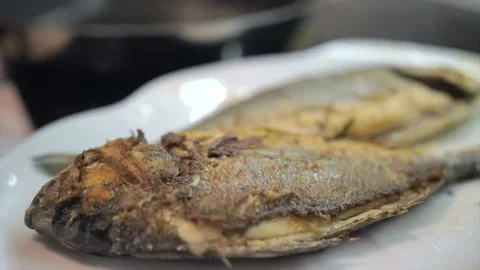 Presentation of fresh sea bream on grill pan ready to cook Stock Footage 132949830