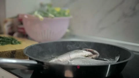 Presentation of fresh sea bream on grill pan ready to cook Stock Footage 132952697