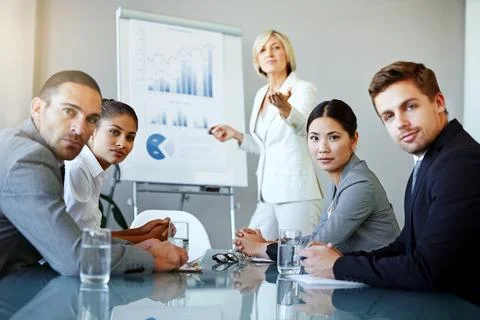 Presentation, graphs on whiteboard with team and question from staff with data Stock Photos