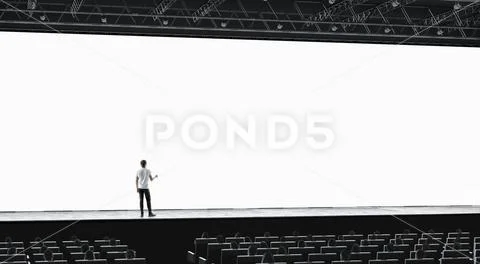 Presentation hall with person on scene auditorium blank screen mockup Stock Photos