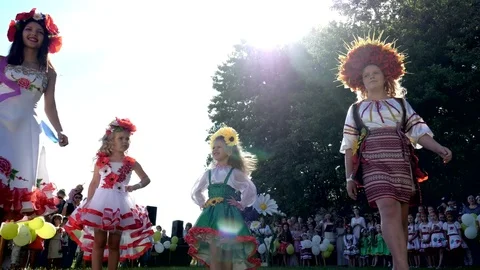 Presentation national costumes alfresco in backlight, parade of embroidery on Stock Footage