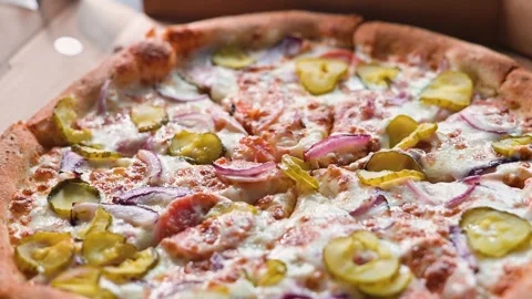 Presentation of a pizza topped with pickles and various vegetables Stock Footage 338290080