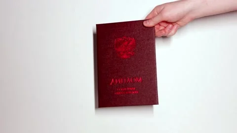 Presentation of the red diploma from hand to hand. Stock Footage 165439367