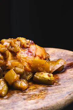 Presentation of roasted chicken with vegetables on a cutting board. Stock Photos