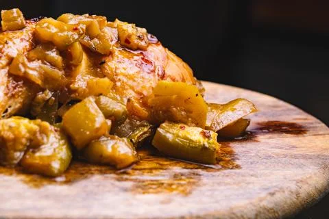 Presentation of roasted chicken with vegetables on a cutting board. Stock Photos