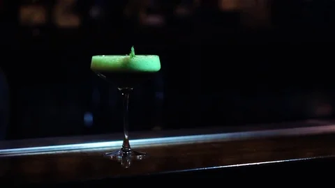 Presentation of tasty mint green cocktail with creme Stock Footage 70772420