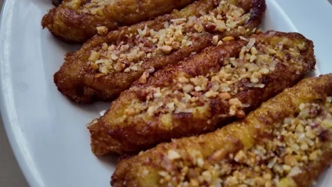 Presentation of Traditional Crispy Fried Bananas with Nuts Stock Footage 335190185