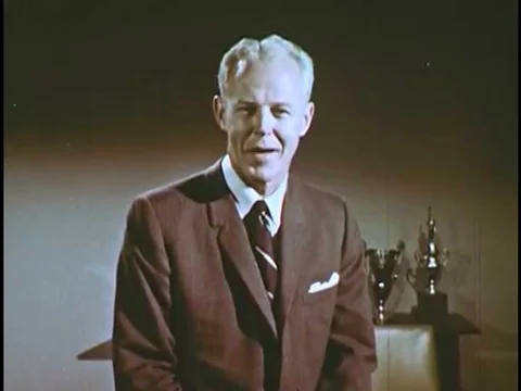 Presenter Bud Wilkinson shows an Ectograph 8 Super 8mm camera, film and an Stock Footage 74876271