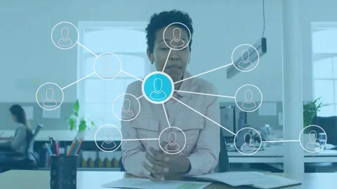 Presenter at desk clasping hands as tech network appearing, gesturing to blue Stock Footage 333368181