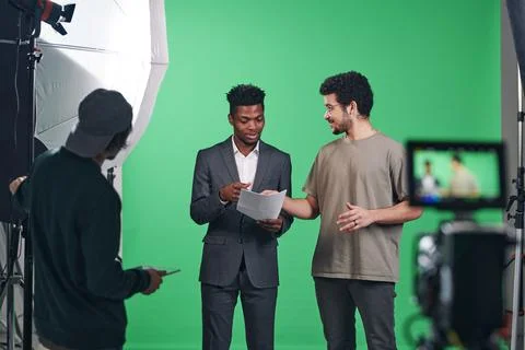 Presenter discussing script with director Stock Photos