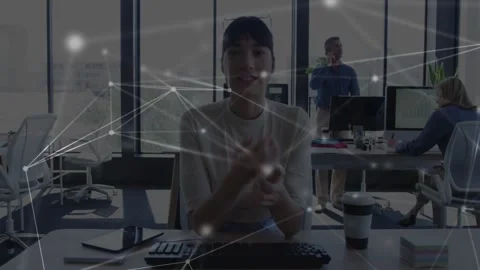Presenter gesturing at desk while network nodes overlay appearing over her, Stock Footage 334037956