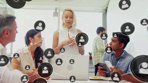Presenter gesturing at laptop at table, causing animated node network Stock Footage 331757301