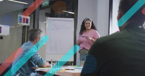 Presenter glancing at flipchart gesturing toward notes and graphs explaining Video stock 314531770