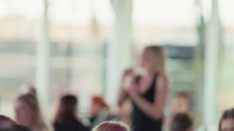 Presenter interacts naturally. Informal yet professional seminar capturing Stock Footage 335687372