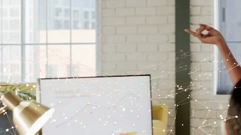 Presenter in office stepping on hand cue, gesturing, reviewing business data as Stock Footage 337579137