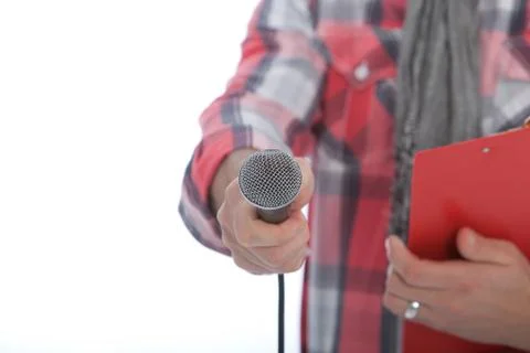 Presenter or interviewer holding out a microphone Stock Photos