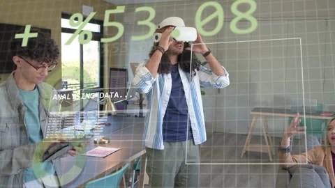 Presenter putting on VR headset in open room, tech HUD analysing data as Stock Footage 333169792
