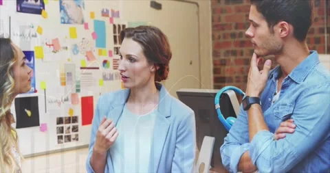 Presenter raising hand pointing at notes board, explaining design plan while Stock Footage 330981076