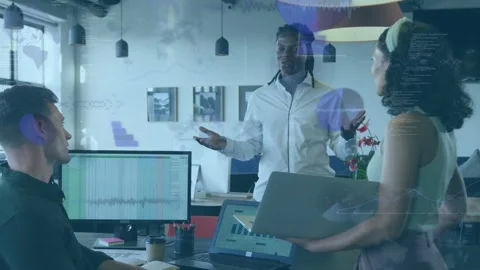 Presenter speaking, starting data charts over laptop during team meeting while Stock Footage 333145483