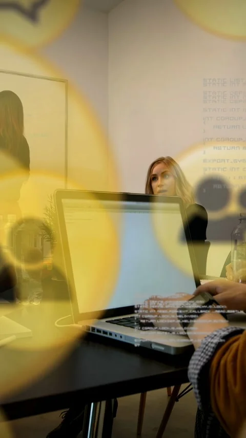 Presenter speaking, team typing on laptop for business, yellow circles obscuring Stock Footage 333079551