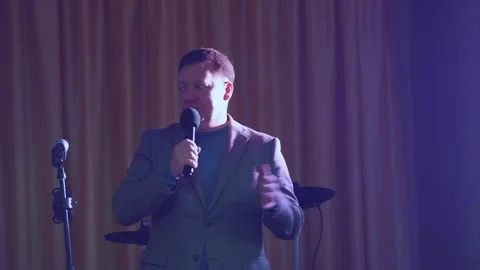 The presenter speaks into the microphone Stock Footage 256872380