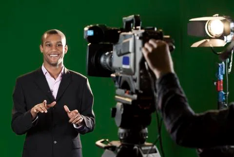 Presenter in studio with tv camera and camera operator Photos