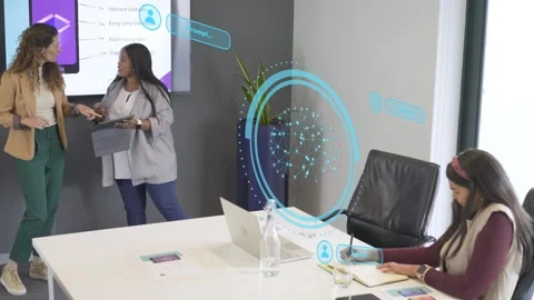 Presenter tapping tablet, activating holograms to annotate phone mockup for 库存影片 333526221