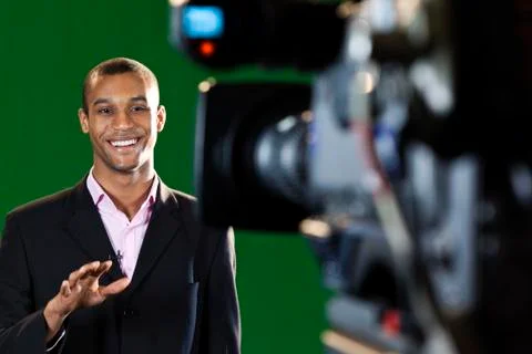 Presenter in tv studio with foreground camera Photos