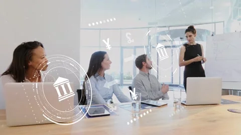 Presenter writing on flipchart, team noting, bank icon and currencies overlaying Stock Footage 333803521