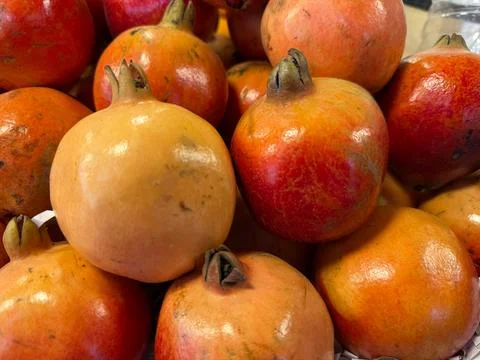 Presenting a closeup image of a group of ripe, whole pomegranates featuring s Foto stock