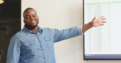 Presenting data on screen in office meeting, business professional gesturing Stock Footage 345804786