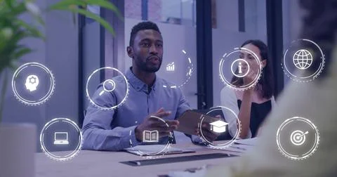 Presenting man in button-up shirt discussing data on tablet at office meeting, Stock Photos