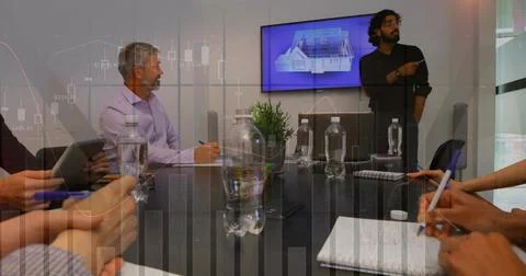 Presenting man gesturing at wall 3D model in boardroom, team in shirts writing, Stock Photos