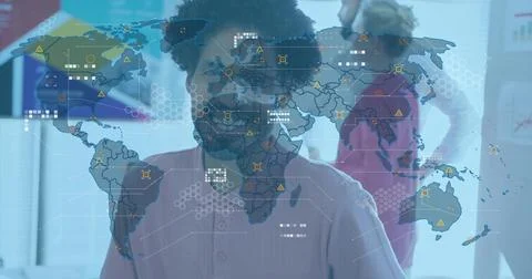 Presenting man wearing light pink shirt pointing at digital world map overlay in Stock Photos