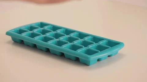 Presenting a plastice ice cube tray Stock Footage 133811468
