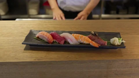 Presenting a plate of fresh nigiri sushi Stock Footage 314320588