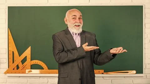 Presenting product. get knowledge here. senior man teacher use math tools 写真素材